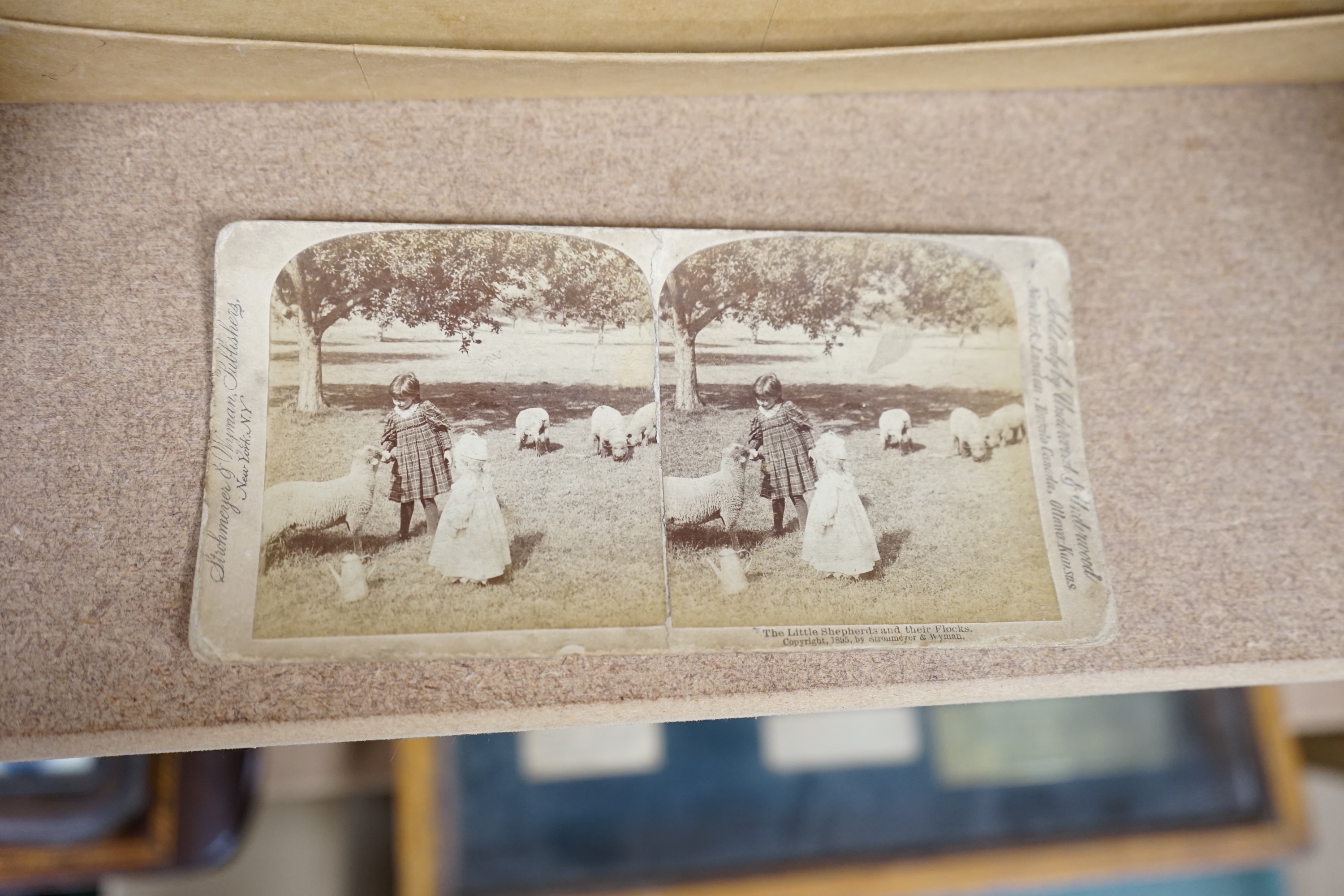 A Cook's patent stereoscope viewer and viewing cards together with a green Morocco leather playing cards box, box 12.5cm high x 24cm wide. Condition, games box poor, viewer and cards good